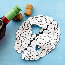 paper cutout of a brain with holes in it, next to a wine bottle and two corks on a blue background; illustration of alcohol-related brain damage