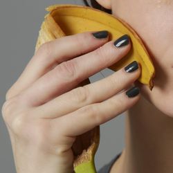 woman rubbing a banana peel on her face