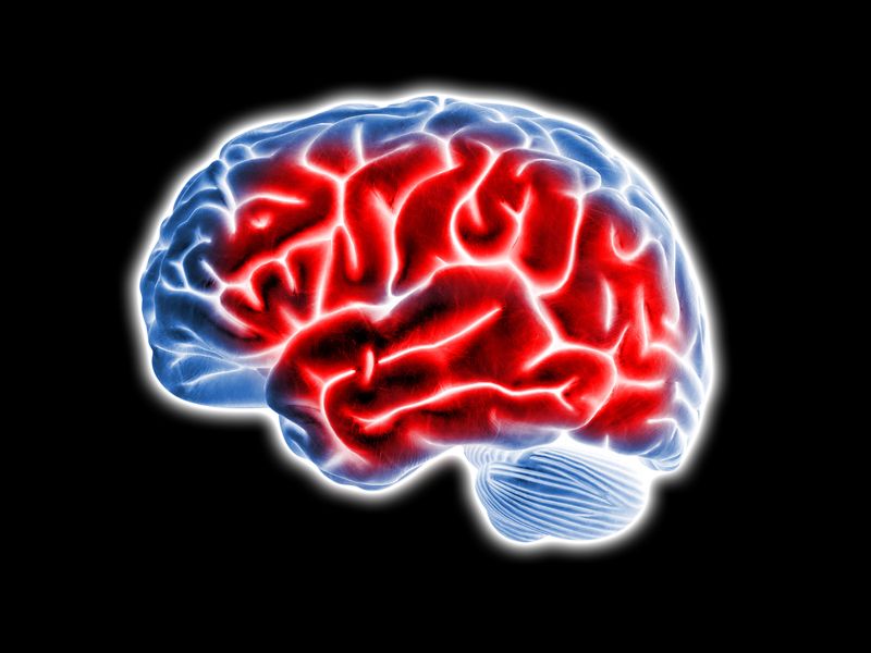 3D illustration of a blue brain on a black background with a large section of red to indicate inflammation.