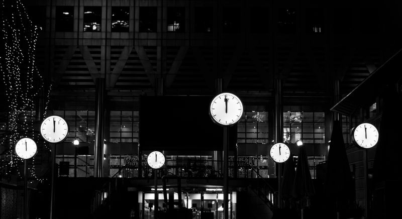 Clocks strike midnight at Reuters Plaza in Canary Wharf, London.