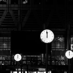 Clocks strike midnight at Reuters Plaza in Canary Wharf, London.