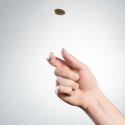 hand flipping a coin