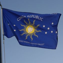 Flag of the Conch Republic (Key West) flying against a blue sky.