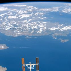 Planet Earth and the International Space Station pictured by an astronaut onboard the Space Shuttle in August 2007