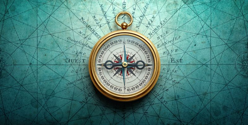 Gold Magnetic old compass on blue world map background