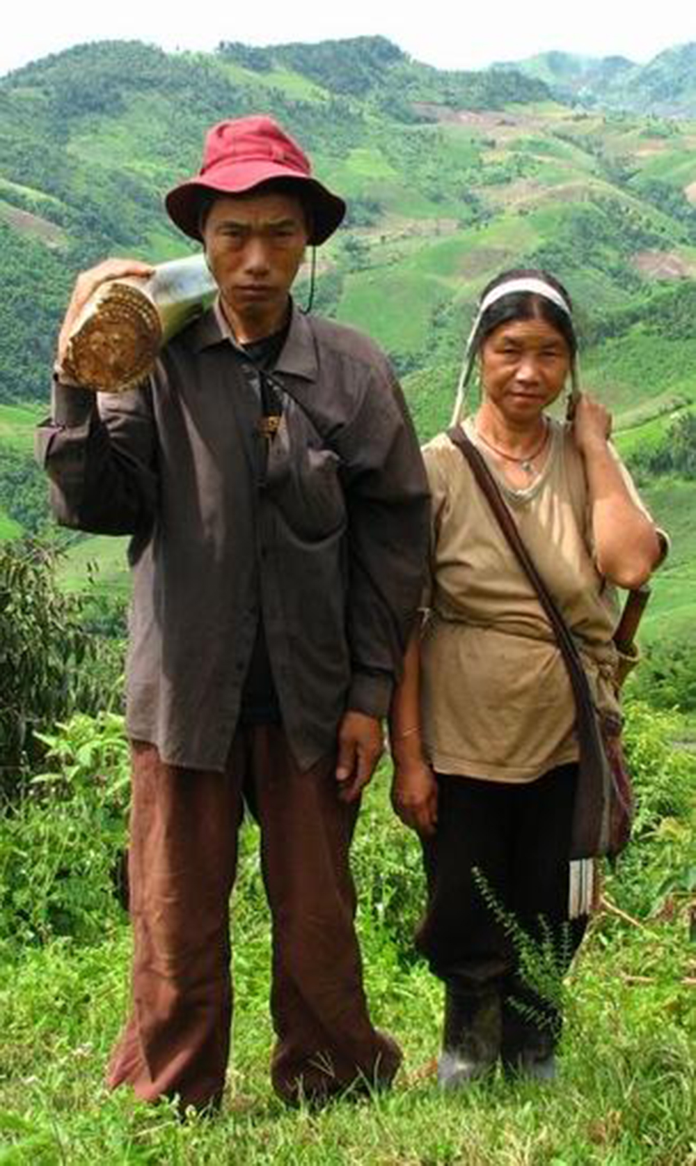 Two humans against a landscape, holding tools. Two humans against a landscape, holding tools.