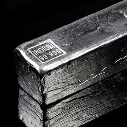 ingot of indium, a silvery white metal, against a black background