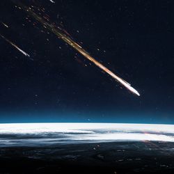 A digital photo showing a meteor about to enter the Earth's atmosphere from out of space. The perspective is from space, looking across a section of the Earth's upper limit as the streak of the comment approaches it. There is a smaller meteor in the background. 