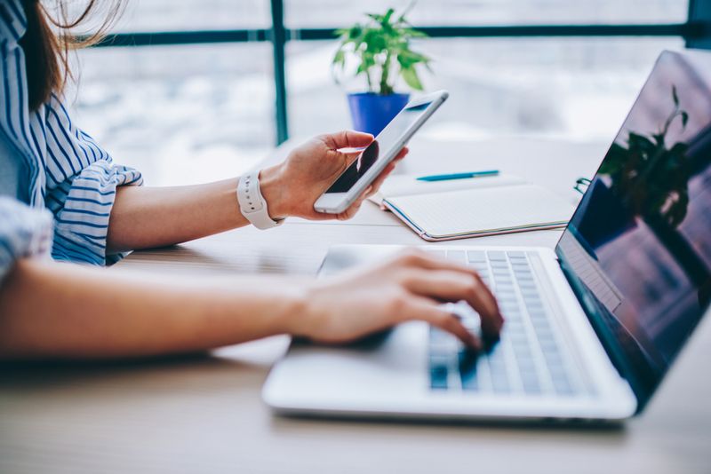 When flipping between phone and laptop, like this woman shown here, don't let the battery of either run so low it gets damaged.