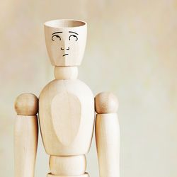 wooden mannequin with empty head and a puzzled face