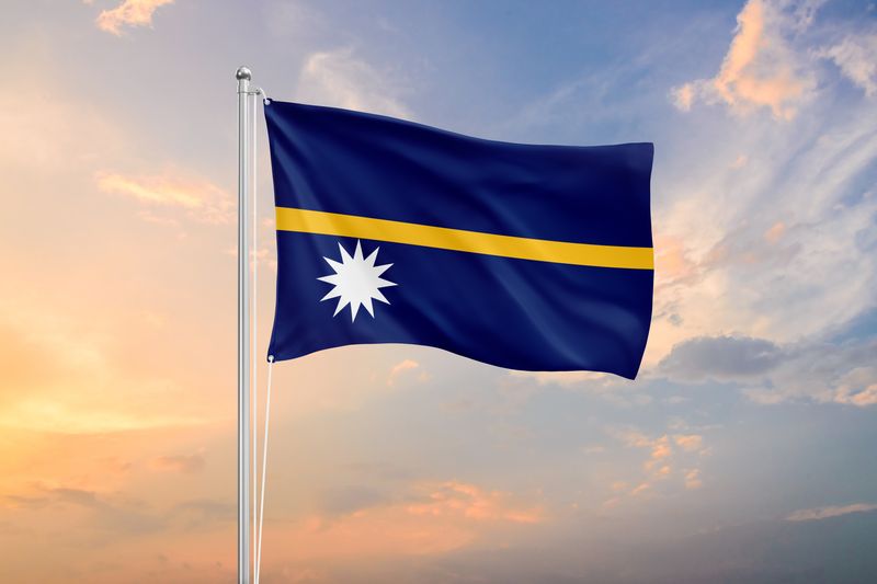Nauru flag waving in front of a sky at sunset