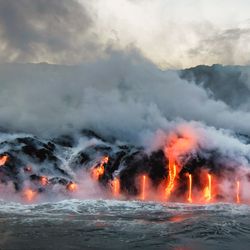 Molten lava flowing into the Pacific Ocean on Big Island of Hawaii. 