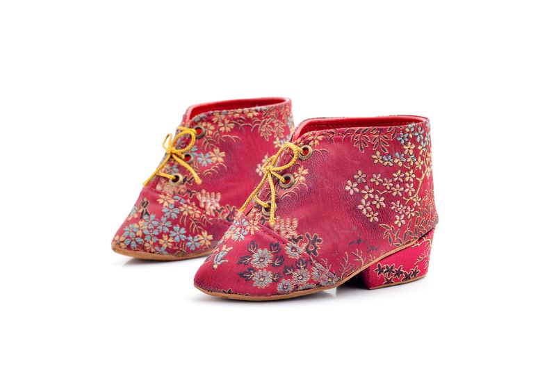 Red lotus shoes on a white background