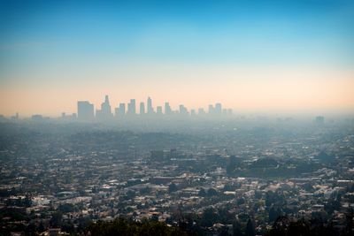 smog over downtown skyscraper buildings and suburbs of Los Angeles from Griffith Park California