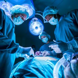 Team of surgeon doctors are performing surgery for a patient in the emergency surgical room