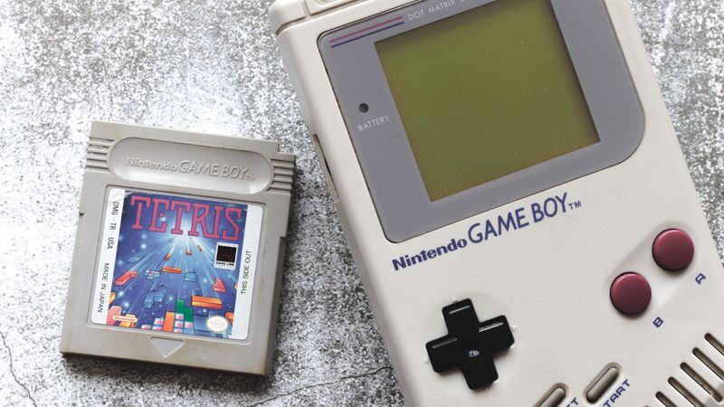 A tetris cartridge next to a game boy