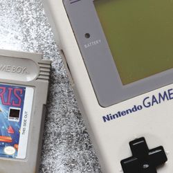 A tetris cartridge next to a game boy