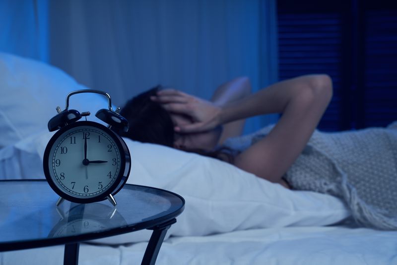 Woman lying awake in bed at 3am