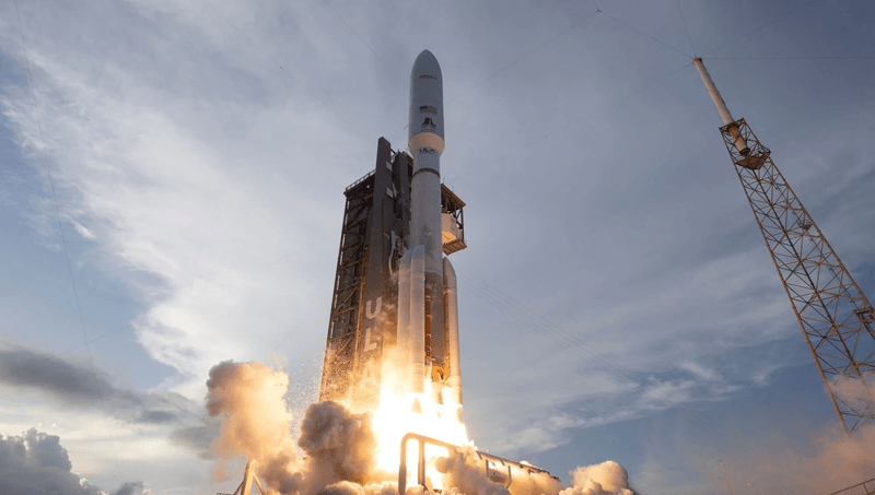 A rocket firing up its engine just moving past the launch tower