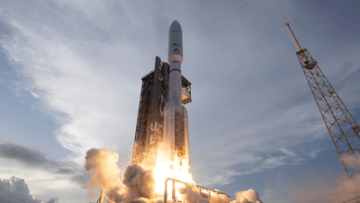 A rocket firing up its engine just moving past the launch tower