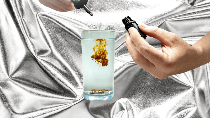 Colloidal sliver supplements being dripped into a glass of water 