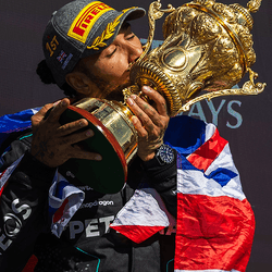 Lewis Hamilton holding a trophy.