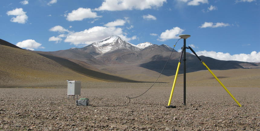 Fancy scientific equipment, including a gravimeter and GPS station, with Uturuncu looming in the background Fancy scientific equipment, including a gravimeter and GPS station, with Uturuncu looming in the background