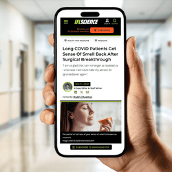 hand holding up phone screen displaying IFLScience article