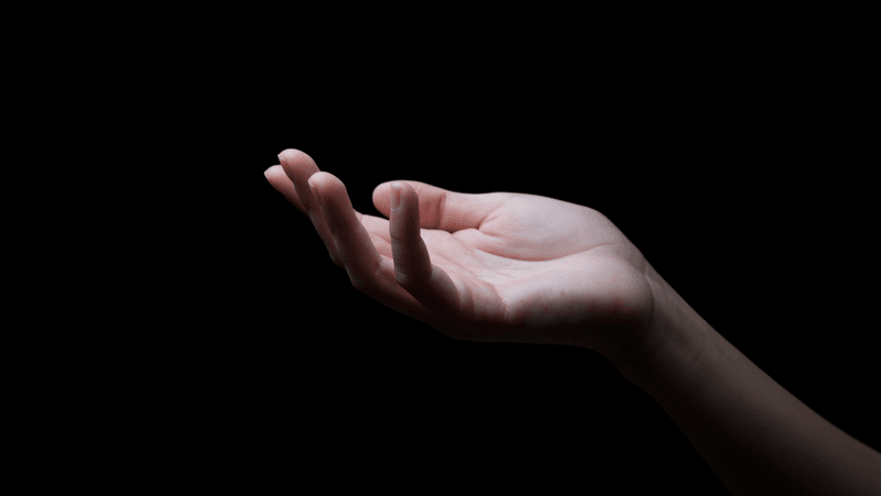 a human hand lit up on a dark background