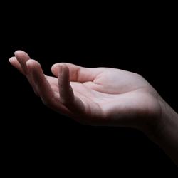 a human hand lit up on a dark background