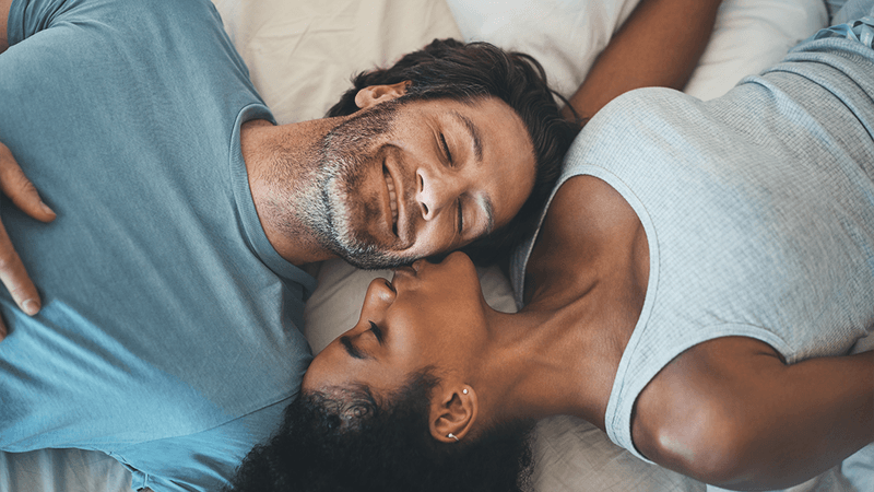 A couple on a bed.