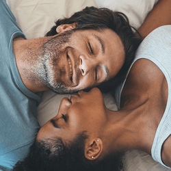 A couple on a bed.