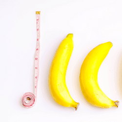 Six bananas next to a measuring tape