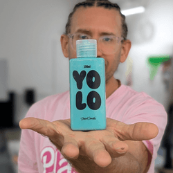 Artist Stuart Semple holds a bottle of YOLO paint inspired by a new color created in a new study