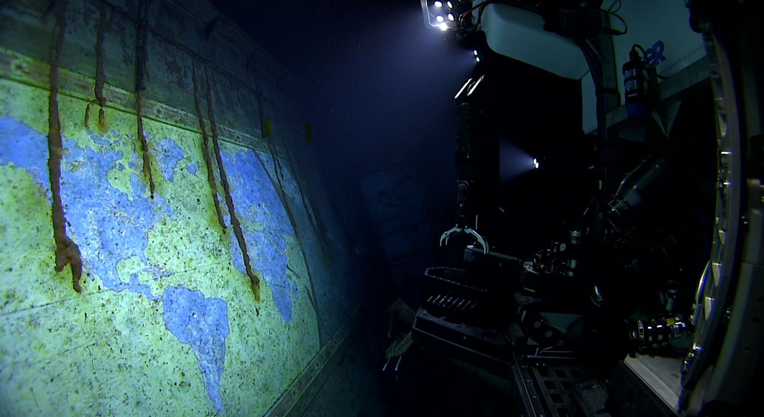 The NOAA's ROV lights up a hand-painted mural called “A Chart of the Cruises of the USS Yorktown." The NOAA's ROV lights up a hand-painted mural called “A Chart of the Cruises of the USS Yorktown."
