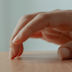 Fingers tapping on a table.