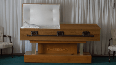 an open casket waiting for embalmed person to go inside
